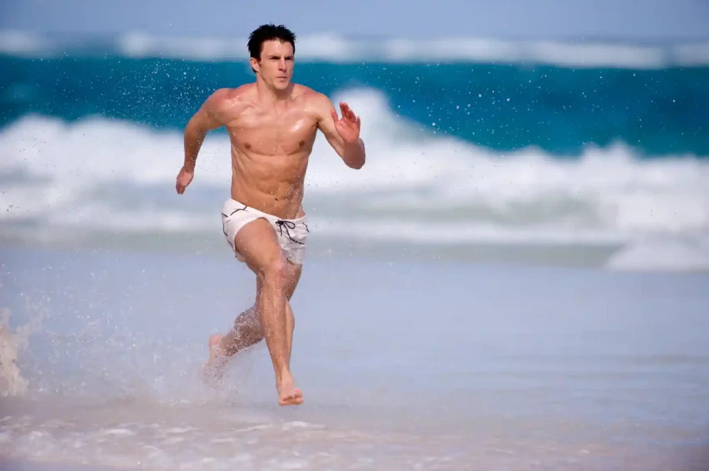 man on beach learning how to become a runner