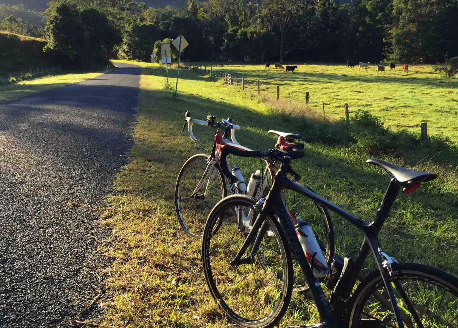 Two road bikes parked on a quiet country road near Currumbin, Queensland