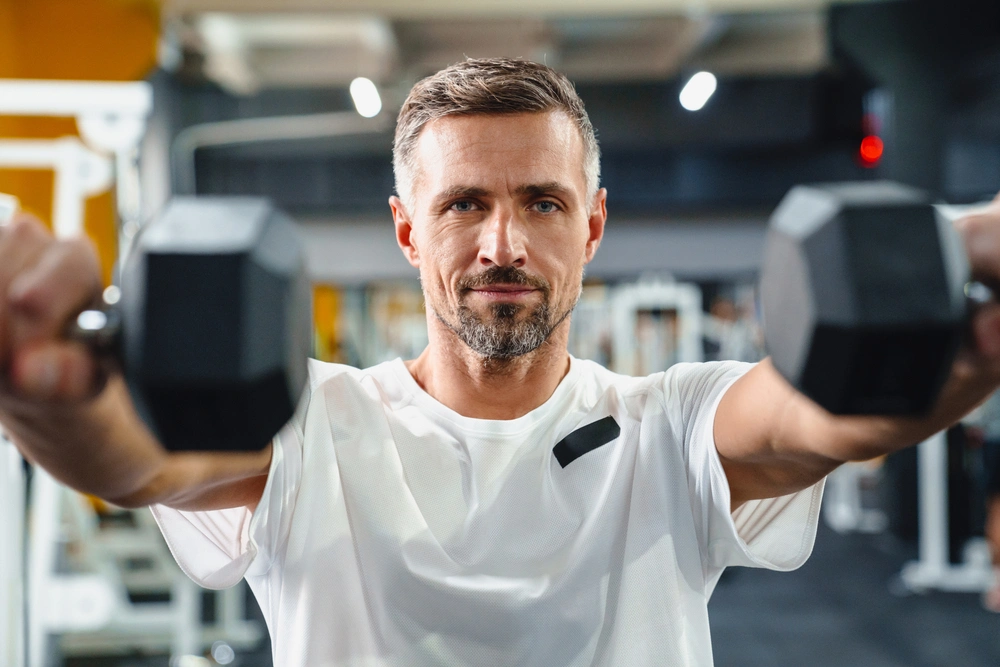 middle age man lifting weights