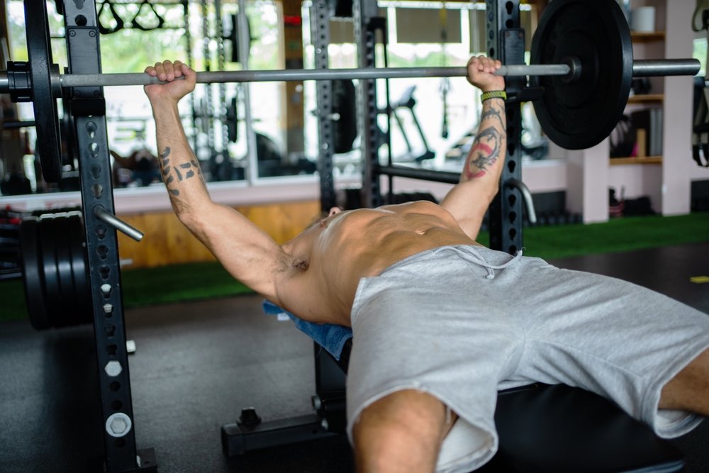 Man bench pressing in a gym