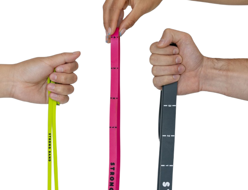 Three hands each gripping a Strong Band resistance band — lime, pink and charcoal — showing the numbered level markings printed along each band