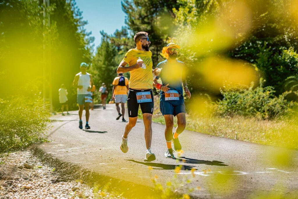 Two runners on a road during a long-distance ultramarathon