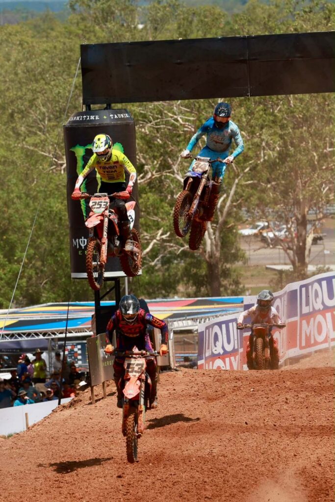 Two motocross riders jump high off a table-top at Hidden Valley Motorsport Complex during the MXGP season finale
